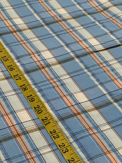 Sky blue, white and rust orange plain seersucker plaid yarn-dyed fabric, with thin navy and yellow lines.