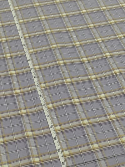 Lilac, pale yellow and white plaid yarn-dyed fabric, with fine solid purple lines.
