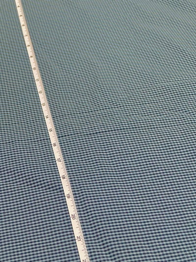 Pastel blue and black plain pin check yarn-dyed fabric.