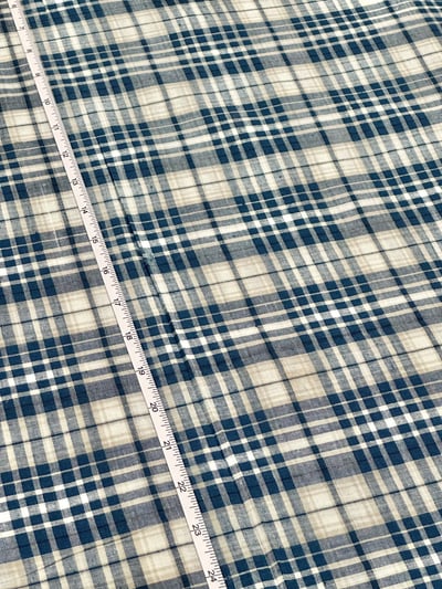 Dark blue, cream and white plaid yarn-dyed fabric.