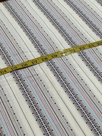 Yarn-dyed multi colour stripe dobby on off-white base, with pink and brown lines and small motif rows.