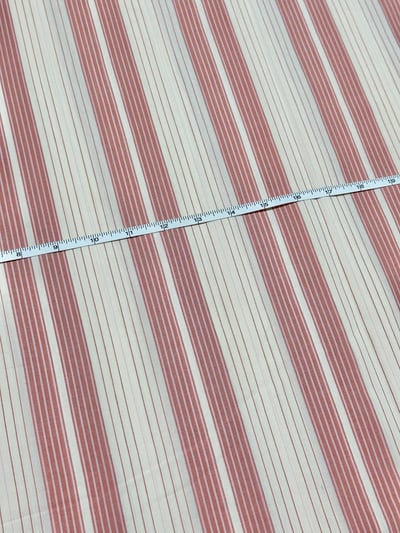 Off-white and brick red multi stripe yarn-dyed fabric, with grouped bands and fine contrast lines.