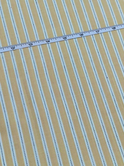 Beige, white and black multi stripe yarn-dyed fabric, with thin black lines centred in white stripes.