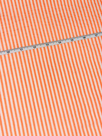 Bright orange and white candy stripe yarn-dyed fabric.